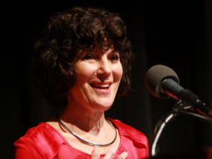 Nancy Buirski smiling in front of microphone